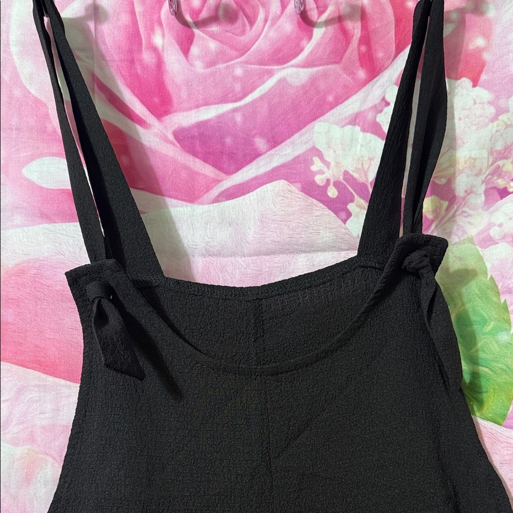 Sleeveless Romper w/laser cut hem at legs. 
2 pockets in front. - Picture 2 of 5